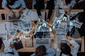 Group of Business Professionals Analyzing Charts and Graphs on Laptops in a Meeting Room with Data Visualization Royalty Free Stock Photo