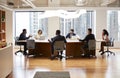 Group Of Business Professionals Meeting Around Table In Modern Office Royalty Free Stock Photo
