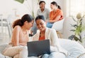 Group of business women on a laptop sitting, laughing looking at social media during a break. Happy ladies bonding on a Royalty Free Stock Photo