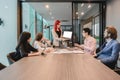 Group of business women meeting in a meeting room with blank screen, sharing their ideas, Multi ethnic Royalty Free Stock Photo