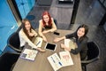 Group of business women meeting in a meeting room with blank screen, sharing their ideas, Multi ethnic Royalty Free Stock Photo