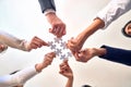 Group of business workers with hands together connecting pieces of puzzle at the office Royalty Free Stock Photo