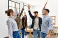 Group of business workers smiling happy standing with hands raised up at the office Royalty Free Stock Photo