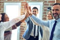Group of business workers standing with hands together highing five at the office Royalty Free Stock Photo