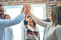 Group of business workers standing with hands together highing five at the office Royalty Free Stock Photo
