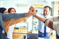 Group of business workers standing with hands together highing five at the office Royalty Free Stock Photo