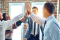 Group of business workers standing with hands together highing five at the office Royalty Free Stock Photo