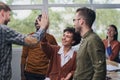 Businessman giving high five to his partner in office Royalty Free Stock Photo