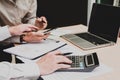 Group businessman hand using calculator on phone Calculating bonus to employees to increase productivity Writing paper on desk. Royalty Free Stock Photo