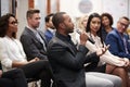 Group Of Businessmen And Businesswomen Applauding Presentation At Conference Royalty Free Stock Photo