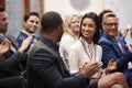 Group Of Businessmen And Businesswomen Applauding Presentation At Conference Royalty Free Stock Photo