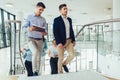 Businessmen and businesswomen walking and taking stairs in an office building Royalty Free Stock Photo