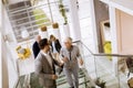 Businessmen and businesswomen walking and taking stairs in an of Royalty Free Stock Photo