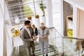 Businessmen and businesswomen walking and taking stairs in an of Royalty Free Stock Photo