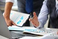 Group of businessmen point arm with silver pen at laptop pc Royalty Free Stock Photo