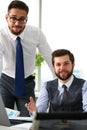 Group of businessmen point arm with silver pen at laptop pc Royalty Free Stock Photo