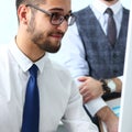 Group of businessmen point arm with silver pen at laptop pc Royalty Free Stock Photo