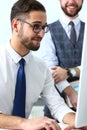 Group of businessmen point arm with silver pen at laptop pc Royalty Free Stock Photo