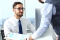 Group of businessmen point arm with silver pen at laptop pc Royalty Free Stock Photo