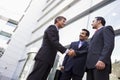 Group of businessmen shaking hands outside office Royalty Free Stock Photo