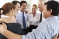 Group Of Businesspeople Bonding In Circle At Company Seminar Royalty Free Stock Photo