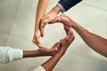 Group of businesspeople hands making creative circle shape together in an office at work. Above diverse business