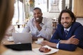 Group Of Businesspeople Having Meeting In Coffee Shop Royalty Free Stock Photo