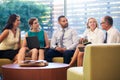 Group Of Businesspeople Having Meeting In Office Lobby Royalty Free Stock Photo
