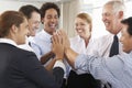 Group Of Businesspeople Joining Hands In Circle At Company Seminar Royalty Free Stock Photo