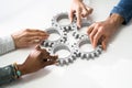 Group Of Businesspeople Joining Together Gears On Table Royalty Free Stock Photo