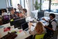 Group of businesspeople in modern open space office talking, smiling. communication, interpersonal relations. relaxed, casual,