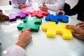 Group Of Businesspeople Solving Jigsaw Puzzle Royalty Free Stock Photo