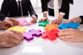 Group Of Businesspeople Solving Jigsaw Puzzle Royalty Free Stock Photo