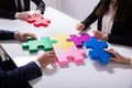 Group Of Businesspeople Solving Jigsaw Puzzle Royalty Free Stock Photo