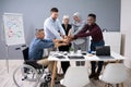 Group Of Businesspeople Stacking Hands Over Desk In Office Royalty Free Stock Photo