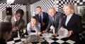 Businesspeople solving conundrum together near chessboard