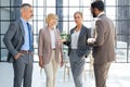 Group of businesspeople standing together in office. Royalty Free Stock Photo