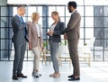 Group of businesspeople standing together in office. Royalty Free Stock Photo