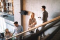 Group of businesspeople walking and taking stairs in an office building Royalty Free Stock Photo