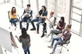 Group of businesspersons cheering and clapping for a co-worker