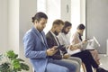 Group of busy people sitting in line in office and waiting for business appointment Royalty Free Stock Photo