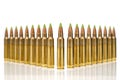 A group of 5.56 calibar, green tip bullets ordered into the line