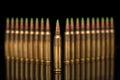 A group of 5.56 calibar, green tip bullets ordered into the lines on black background