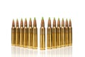 A group of 5.56 calibar, green tip bullets ordered into the lines on white background
