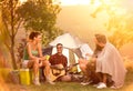 Group of campers next tent having fun with guitar Royalty Free Stock Photo