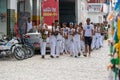 Group of capoeira practitioners walking towards the square