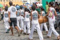 Group of capoeira practitioners walking towards the square