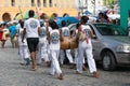 Group of capoeira practitioners walking towards the square