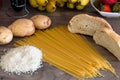 Group of carbohydrates for diet - bread, rice, potatoes and pasta on a wood table