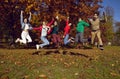 Group carefree young happy people have fun jumping in nature in beautiful golden park. Royalty Free Stock Photo